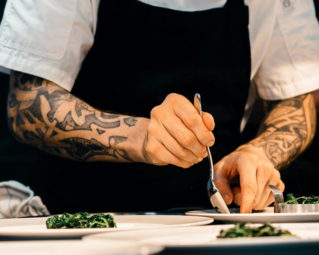 Chef plating dishes on the line during service