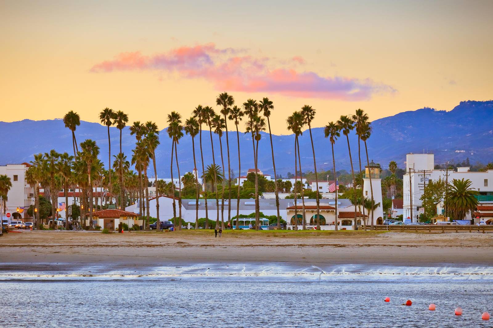 Santa Barbara waterfront at sunset — palm trees along Cabrillo Boulevard with the mountains behind